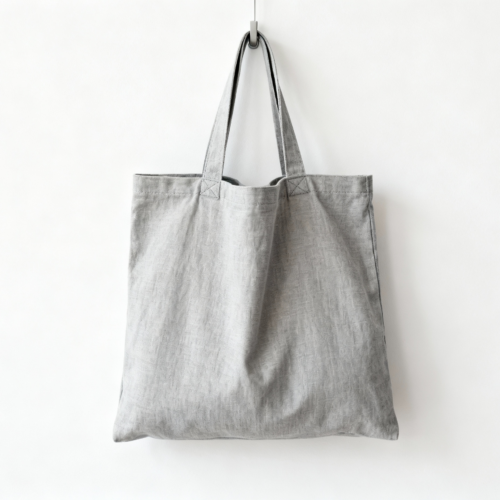 Attributes: type: Tote bag material: Canvas size: Medium handle: Short handle aspect ratio: 3:4 (Portrait - 4:3 flipped) color palette: Neutral:Light Gray:#D3D3D3 background: hanging on a hook negative prompt: people, hands, fingers, multiple bags, person holding